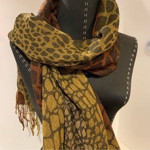 Animal print scarf with fringe. Scarf has a nice  Sheen /sparkle. Approx. 64”